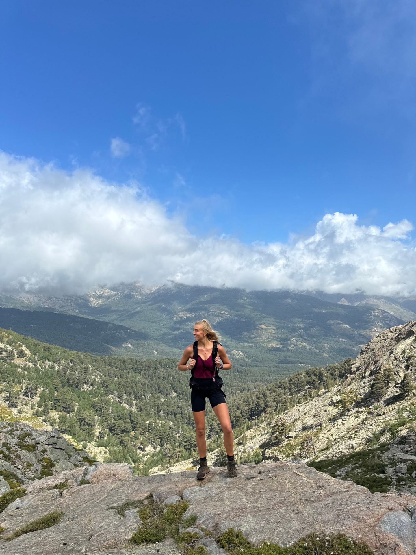 Zanna van Dijk stands atop a mountain in Corsica