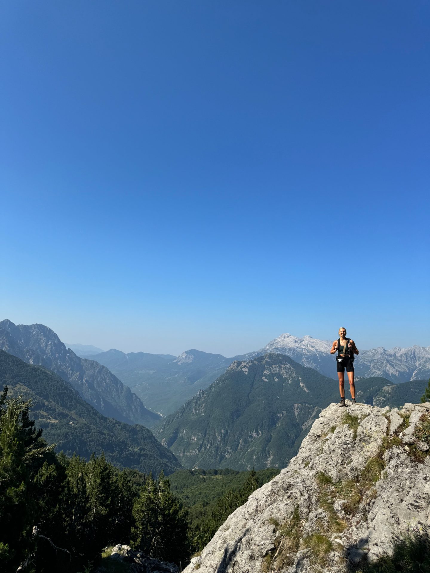 Zanna van Dijk stands atop a mountain in Albania